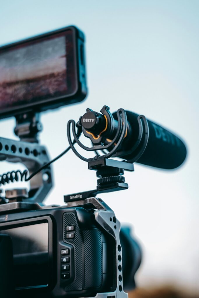 Detailed shot of a camera setup with a microphone, monitor, and rig, ideal for video production.